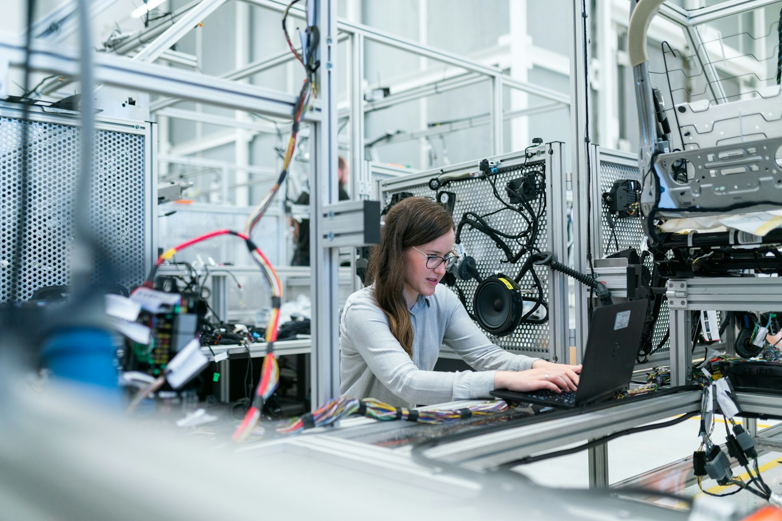 Engineer working with connected equipment on a manufacturing floor